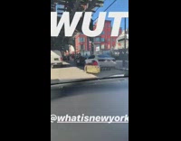 WUT person in yellow and red cart on ny street