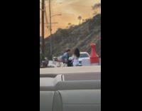 Guy narrate two girls take picture car