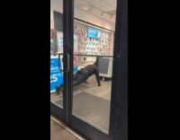 Man black jacket doing pushup inside store