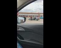 Red jacket guy dances car parking lot 