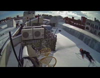 Guy makes snow angel outside on rooftop 