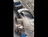 Broken fire hydrant spraying water all over cars on street