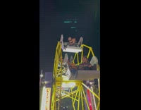 Brother Comforts Its Younger Sibling on Ferris Wheel