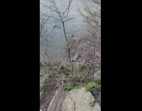 Woman red bikini flex butt beach rock