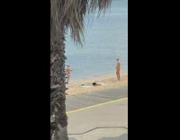 Man runs and then fell down to the beach shore