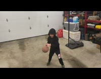 Little boy does tricks shooting basketball 