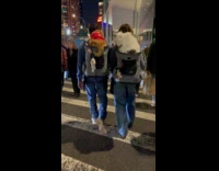 Collab winy - Couple walking carrying cats on top of backpack