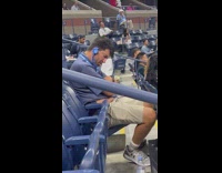 Guy sleeps at tennis game 