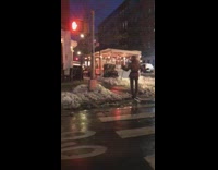 Lady wearing white skis walks across street 