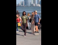 Man wearing horse mask sitting on bench