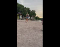 Man in white top walks in the lake at sunset