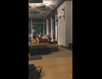 Guy poses with drink front of window 