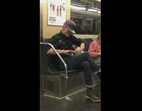 Man clips finger nails then brushes them onto the floor on subway train