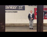 Woman across train tracks dance on platform
