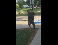 Guy hangs metal pole parallel to ground 