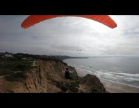 Paragliders crash into rock near beach after wind turbulence collapses wing