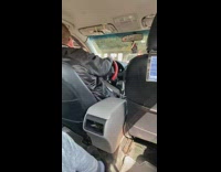 Driver with seatbelt around car gear stick 