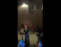 Man in opened pink polo poses in front of the wall