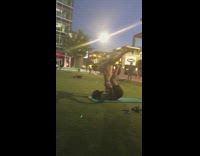 Guy lays down holds girl up feet