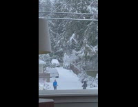 Woman blue jacket kick up throw snow