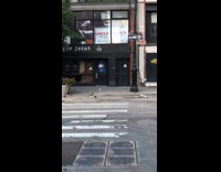 a person carrying lots of gold balloons walking in street
