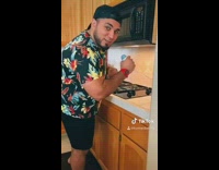 Black laptop music kitchen guy dances 