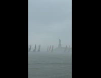 Boats sail near statue of liberty rainy