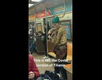 Green beanie guy plays violin on train 