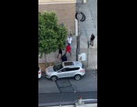 Two men fight each other on sidewalk