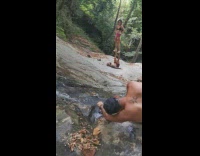 Woman black top stands on feet of man in balance