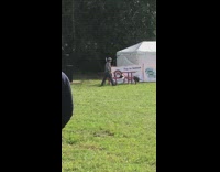 Grey camouflage jacket guy dances hula hoop 