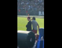 Woman sees handsome man from the opposing team