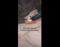 Guy uses his dog charger on phone 