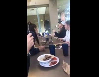 Girls throwing green ball with forks table