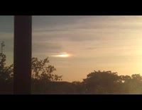 Two sunrise orange sky filmed through window