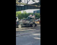 Black pickup truck found crashed on top of road barrier 