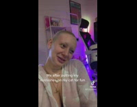 Girl puts eyelashes on cat