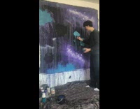 Compilation of videos of a guy painting a mural on an empty white wall 
