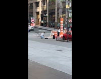Woman pose on street with road construction equipment