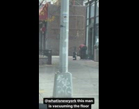 Man clean use vacuum cleaner at street in NY 