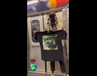 Collab Subway Creatures - Man Holds Up Shirt with Artist on Subway