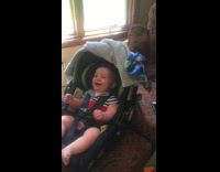Woman make baby laugh hard child seat