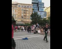 Guy in plaza gets punched from behind and jumped by street performers 