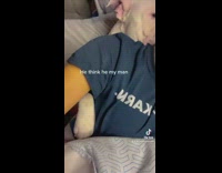 Dog laying in bed spoons woman 