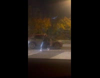 Woman dances side of car while traffic