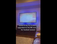 Guy husband watches football on phone television 