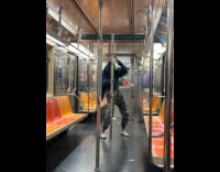 Man ride subway wears jacket one hand