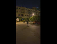 Lady in Skirt and Pads Trips from Skateboard