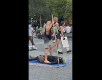 Guy stands on top of man at park 