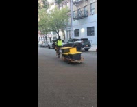 Man bike wheelie stunt while pulling boxes
